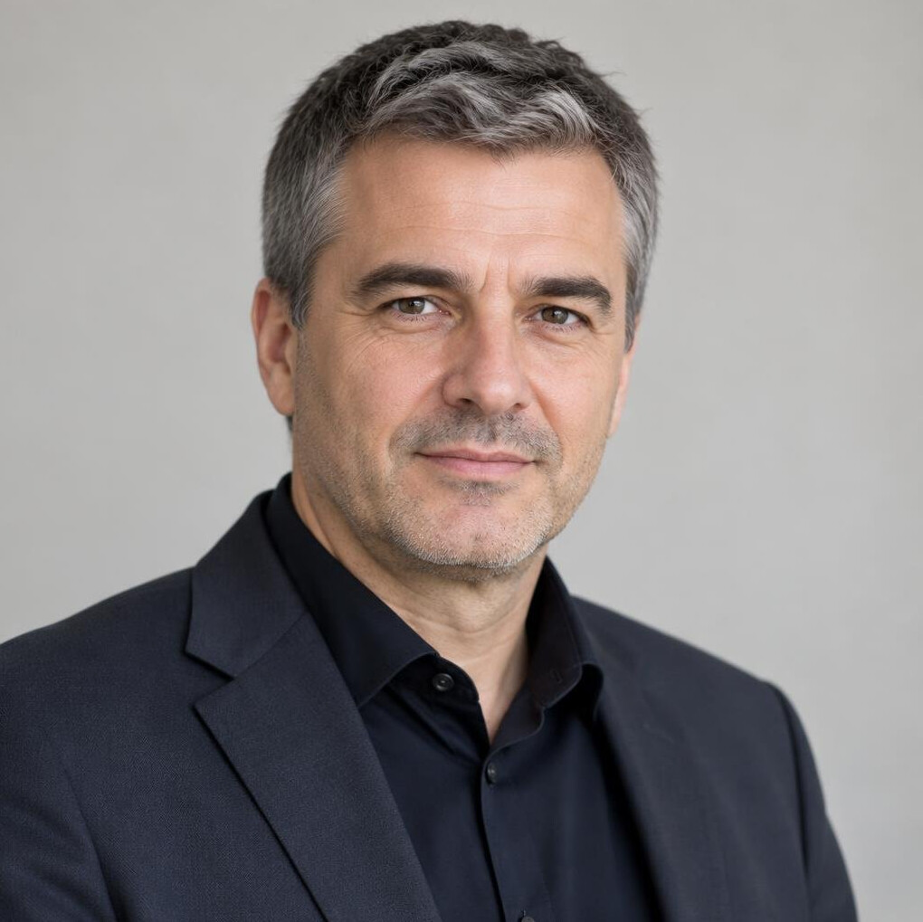 Portrait of a man in a suit with a confident expression