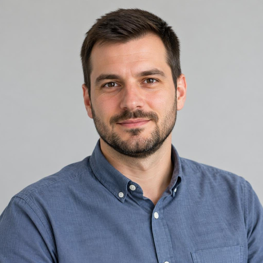 Portrait of a smiling man with short hair and a beard